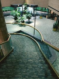 High angle view of staircase by swimming pool against building