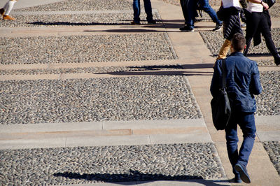 High angle view of people walking on cobbled footpath