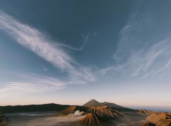 View of volcanic landscape against sky during sunset