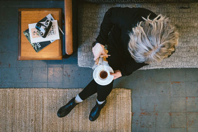 High angle view of woman sitting on road