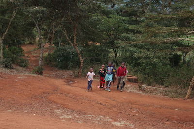 Rear view of people enjoying in forest