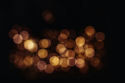 Low angle view of illuminated lights at night