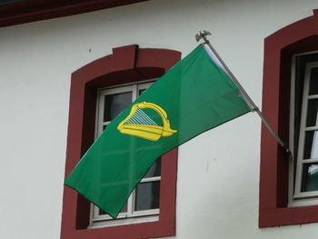 Low angle view of flag flags hanging on wall