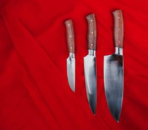 High angle view of red and knife on table