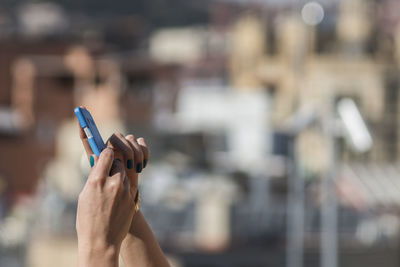 Cropped image of woman using mobile phone