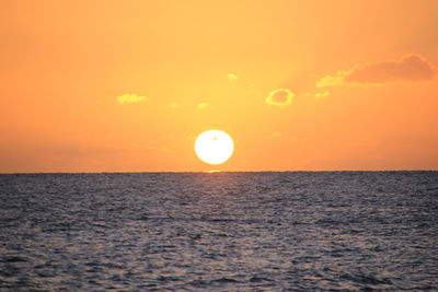 Scenic view of sea against orange sky