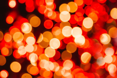 Defocused image of illuminated christmas lights at night