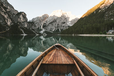 Scenic view of lake by snowcapped mountains against sky