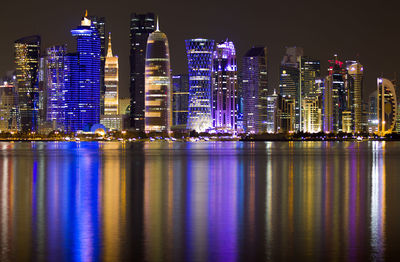 Illuminated buildings in city at night. doha. qatar