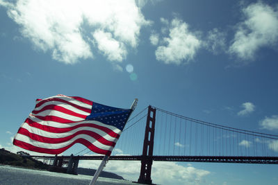 Low angle view of flag against blue sky