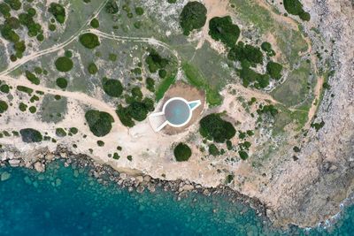 High angle view of hole on rock by sea