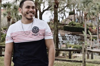 Portrait of smiling young man standing outdoors