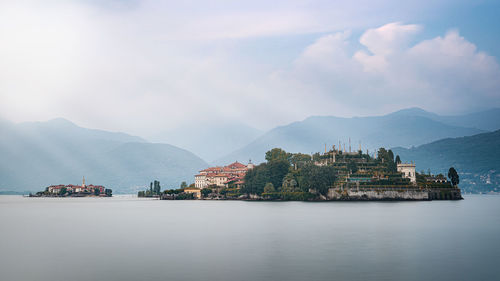 Scenic view of sea by city against sky