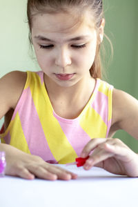 Close-up of girl drawing on book at home