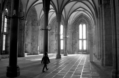 Man walking in corridor of building