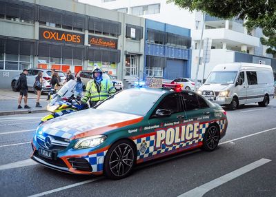 Vehicles on road against buildings in city