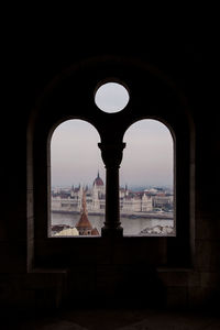 Buildings seen through arch window