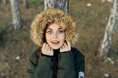 Portrait of smiling young woman standing outdoors