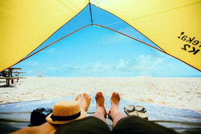 Low section of couple lying in tent