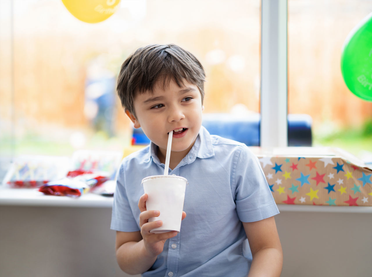 PORTRAIT OF BOY HOLDING ICE CREAM CONE