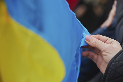 Midsection of man holding flag