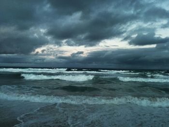 Scenic view of sea against cloudy sky