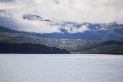 Scenic view of mountains against cloudy sky