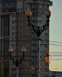 Low angle view of street light against buildings