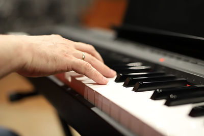 Midsection of man playing piano