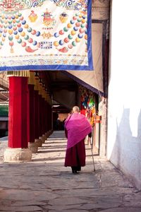 Full length of woman standing on railing
