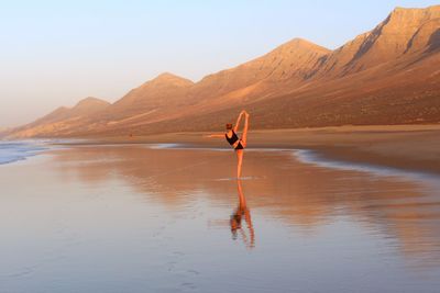 Woman on beach against sky