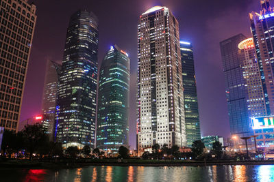 Low angle view of skyscrapers lit up at night