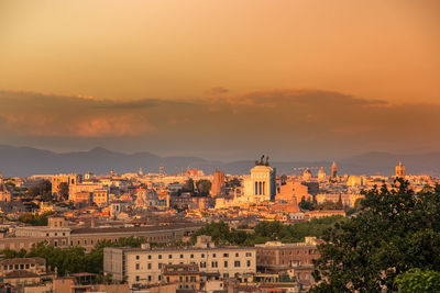 View of the statue of traiano with ancient churches and city of rome in background. roma postcard