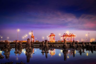 Panoramic view of illuminated city against sky at night