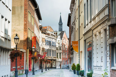 Street amidst buildings in city against sky