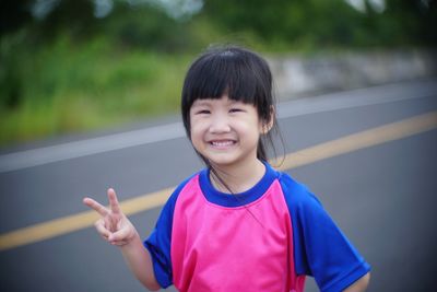 Portrait of smiling girl standing outdoors