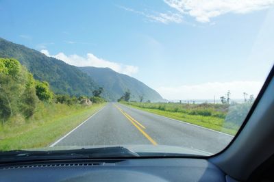 Scenic view of landscape seen through car windshield