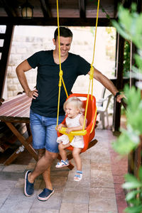 Boy swinging in playground