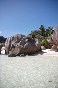 View of rocks against clear blue sky