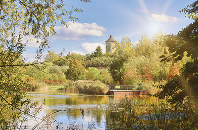 Scenic view of lake by building against sky