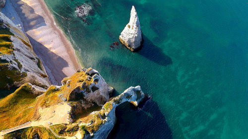 High angle view of sea by mountain