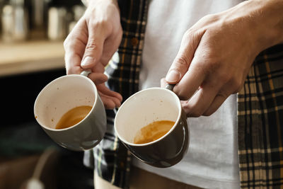 Midsection of coffee cup on table