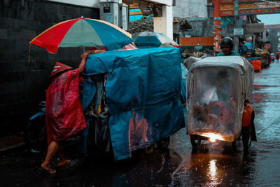 Rear view of man standing in wet rainy season