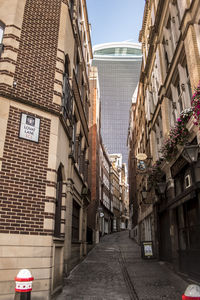 Narrow alley amidst buildings in city