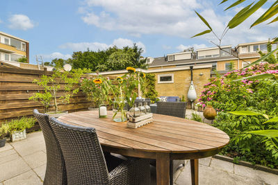 Empty chairs and tables in yard