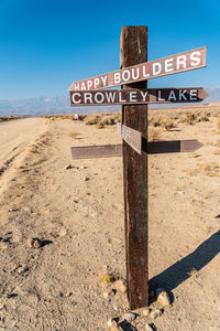 Rural wooden road sign for happy boulders and crowley lake