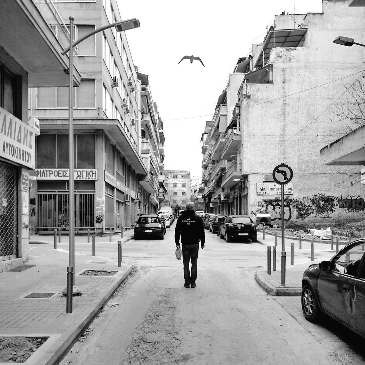 building exterior, architecture, built structure, walking, street, men, full length, rear view, city, transportation, lifestyles, person, city life, road, the way forward, bird, animal themes, on the move