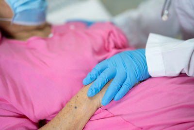 Cropped hand of doctor consoling patient at hospital