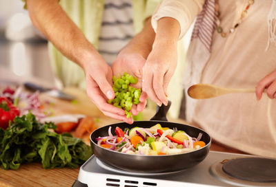 Midsection of man preparing food