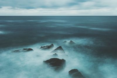 View of calm sea against cloudy sky